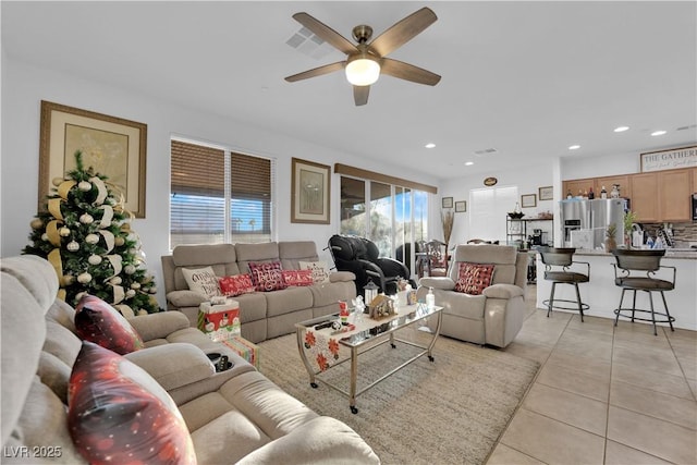 living room featuring light tile patterned floors and ceiling fan