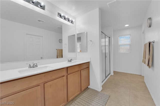 bathroom featuring tile patterned floors, vanity, and walk in shower