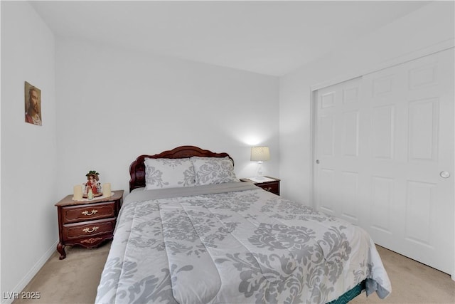 bedroom with a closet and light colored carpet