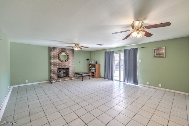 unfurnished living room with a textured ceiling, ceiling fan, a brick fireplace, and light tile patterned floors