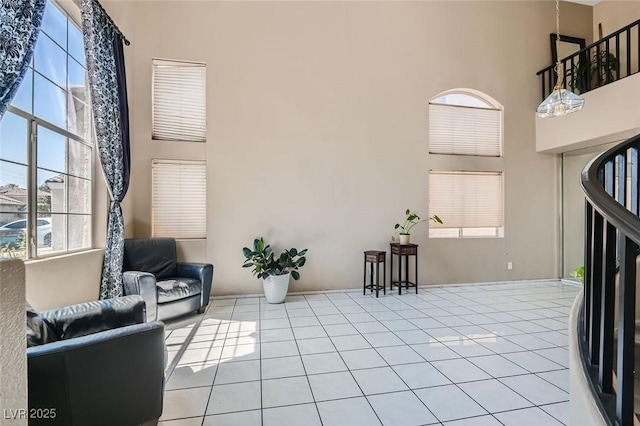 tiled entryway featuring a towering ceiling