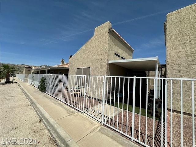 view of property exterior featuring a carport