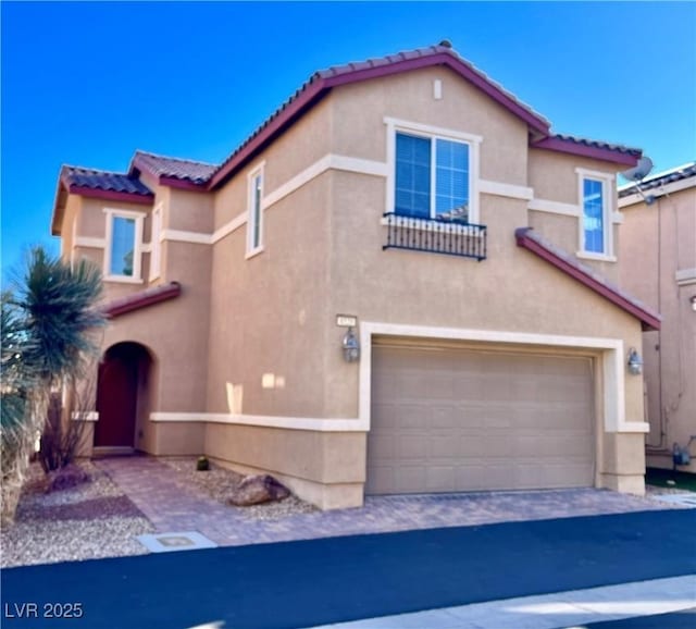 mediterranean / spanish house featuring a garage