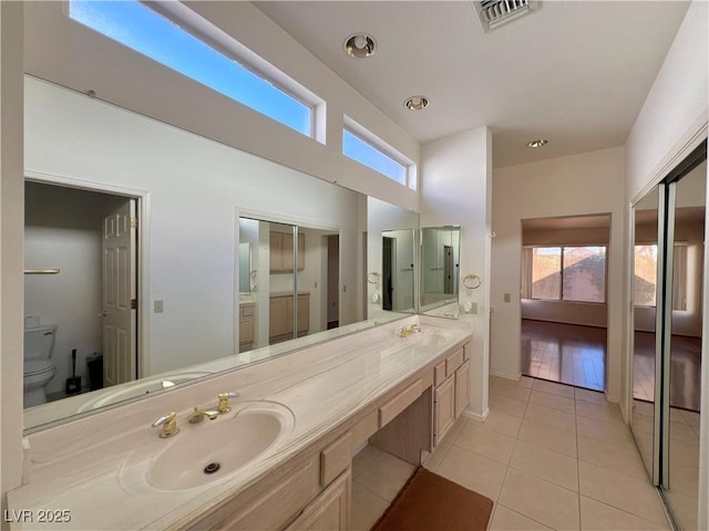 bathroom with tile patterned floors, vanity, and toilet