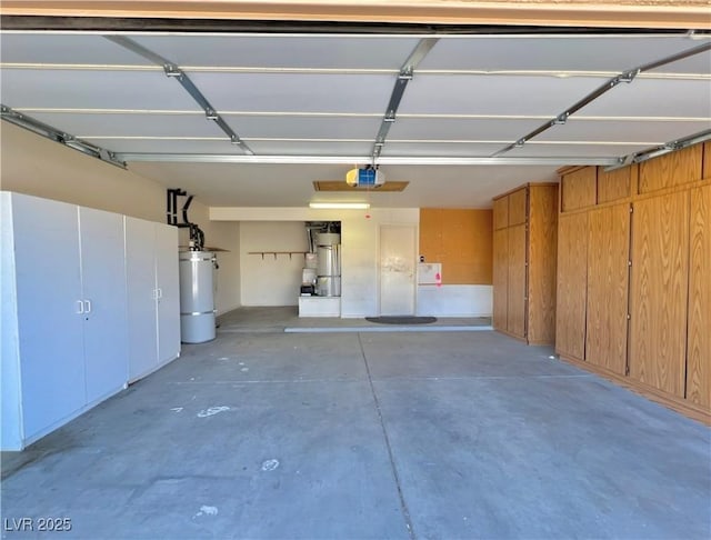 garage featuring a garage door opener and water heater