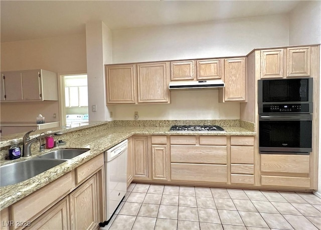 3012 Morning Ridge Dr, Las Vegas, NV 89134 - kitchen featuring stainless steel appliances, light brown cabinets, light tile patterned flooring, under cabinet range hood, and washer / clothes dryer