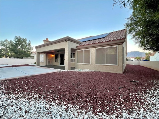 3012 Morning Ridge Dr, Las Vegas, NV 89134 - back of house featuring a ceiling fan, solar panels, a tile roof, a patio area, and a fenced backyard