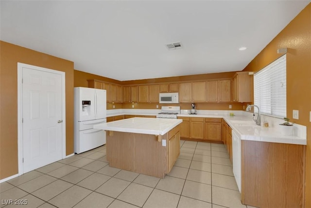 kitchen with sink, a kitchen island, white appliances, and light tile patterned floors