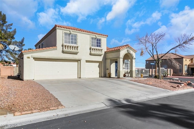 mediterranean / spanish home featuring a garage