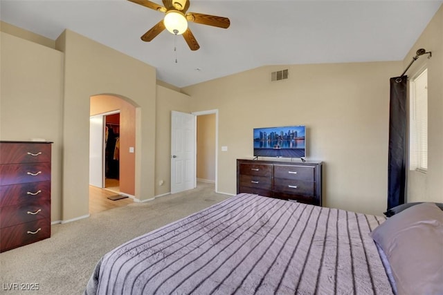 bedroom with ceiling fan, light colored carpet, and vaulted ceiling