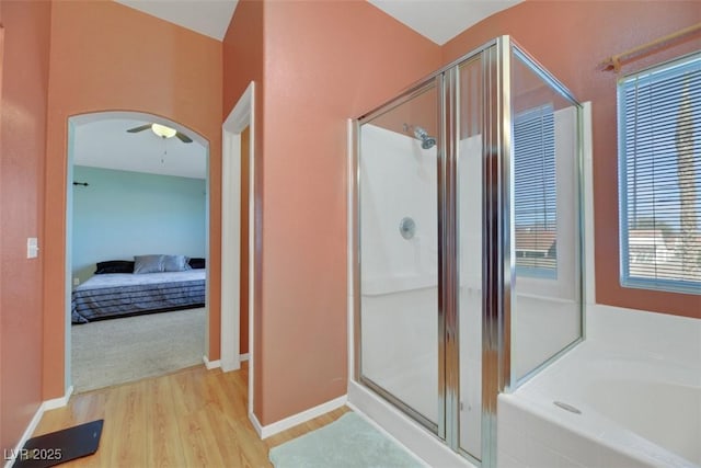 bathroom with independent shower and bath and hardwood / wood-style floors