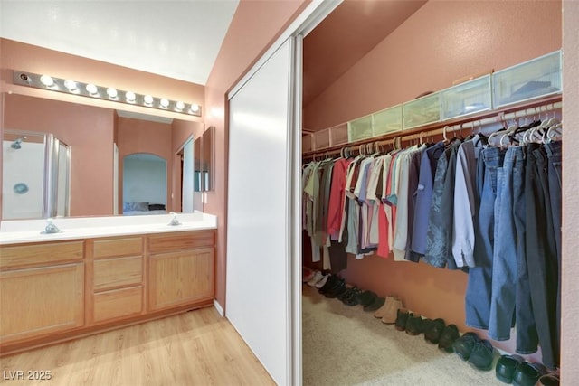 bathroom featuring vanity, vaulted ceiling, an enclosed shower, and hardwood / wood-style flooring