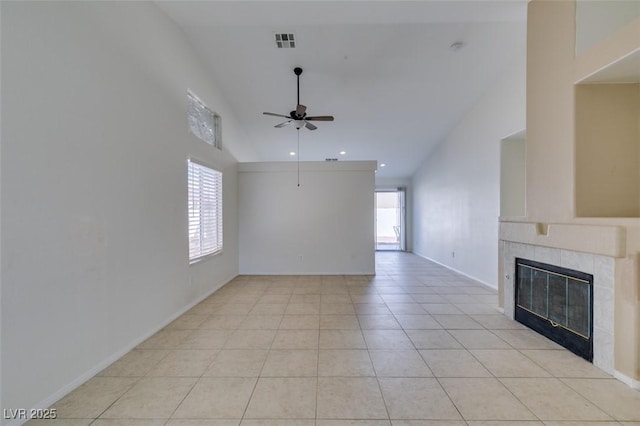 unfurnished living room with ceiling fan, light tile patterned floors, a fireplace, and lofted ceiling