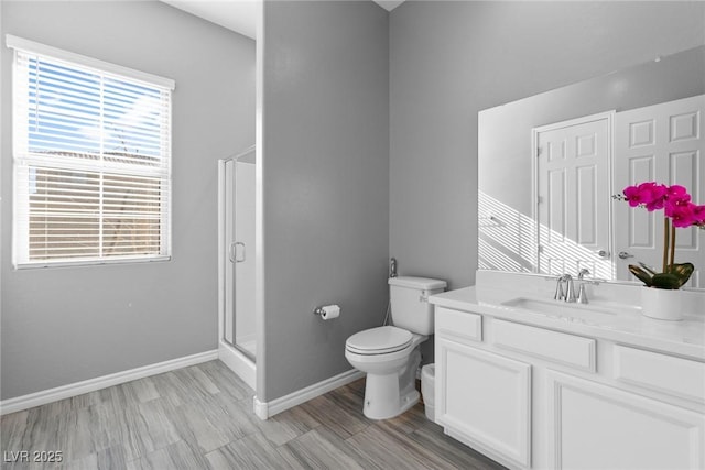 bathroom featuring an enclosed shower, vanity, and toilet