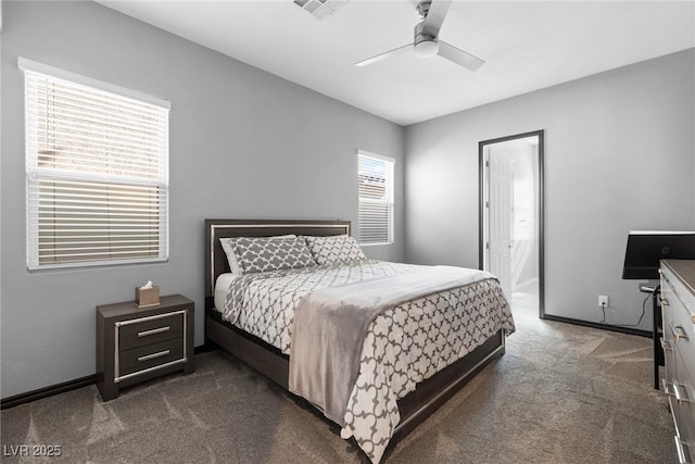 bedroom with dark carpet, ceiling fan, and ensuite bathroom