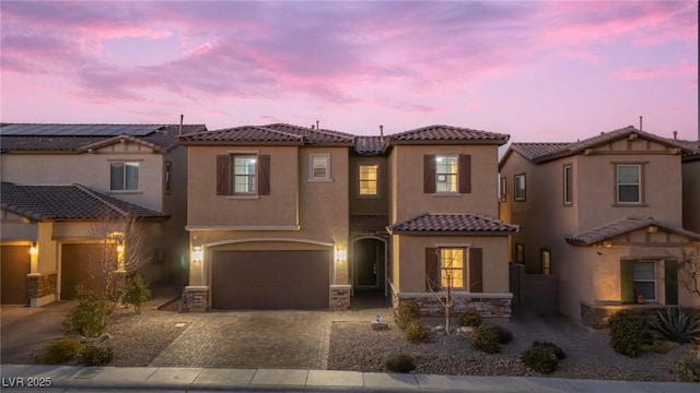 mediterranean / spanish-style home with a garage