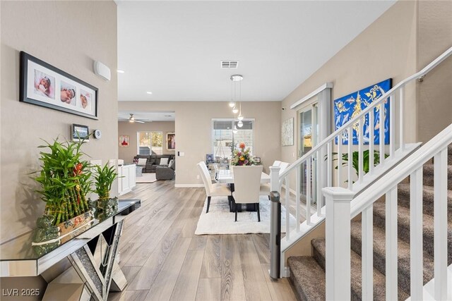 interior space featuring ceiling fan and light wood-type flooring