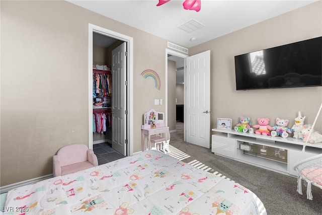 carpeted bedroom featuring ceiling fan and a spacious closet