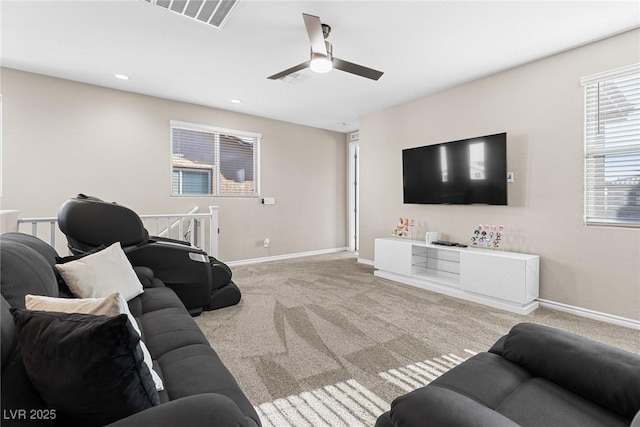 carpeted living room with ceiling fan