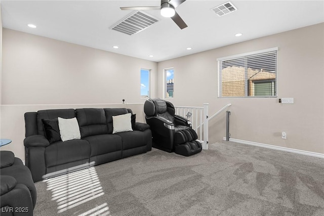 carpeted living room featuring ceiling fan and plenty of natural light