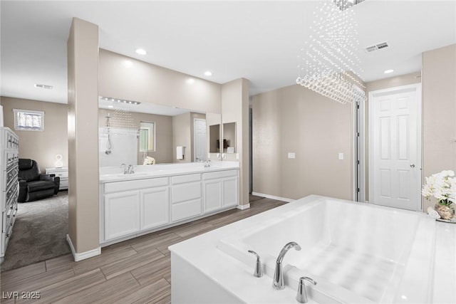 bathroom featuring a tub and vanity