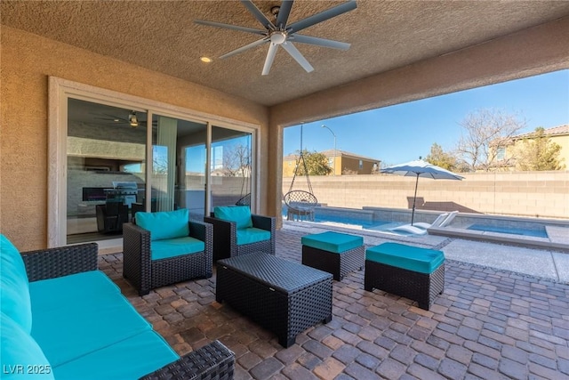 view of patio / terrace with outdoor lounge area, a swimming pool with hot tub, and ceiling fan