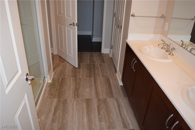 bathroom featuring vanity and a shower with door