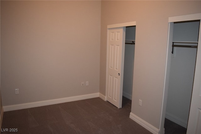 unfurnished bedroom with dark colored carpet