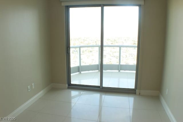 unfurnished room featuring light tile patterned floors and a wealth of natural light