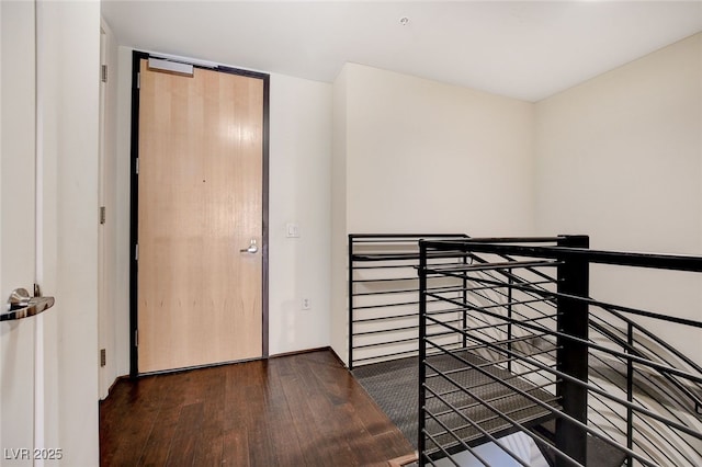 unfurnished bedroom with dark hardwood / wood-style flooring and a closet