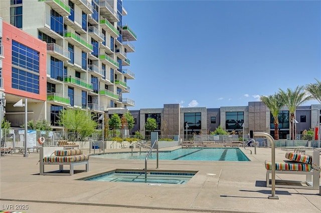 view of swimming pool featuring a hot tub