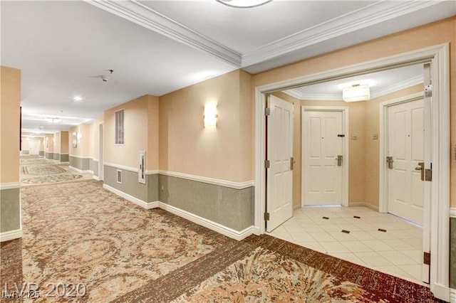 hall featuring light tile patterned floors and ornamental molding