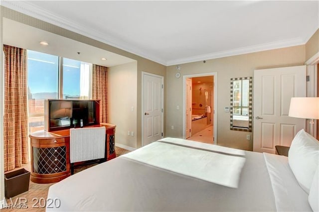 bedroom featuring connected bathroom, light hardwood / wood-style floors, and ornamental molding