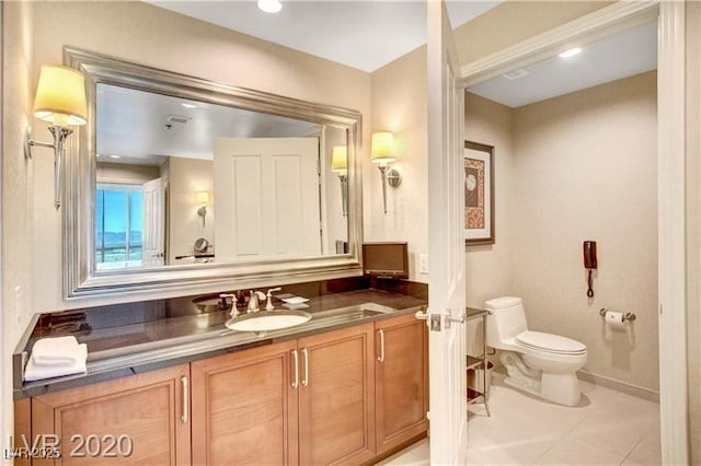 bathroom featuring tile patterned floors, vanity, and toilet