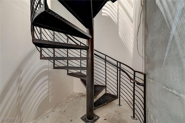 stairway featuring concrete flooring