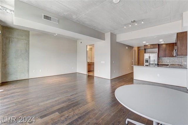 unfurnished living room with dark hardwood / wood-style floors