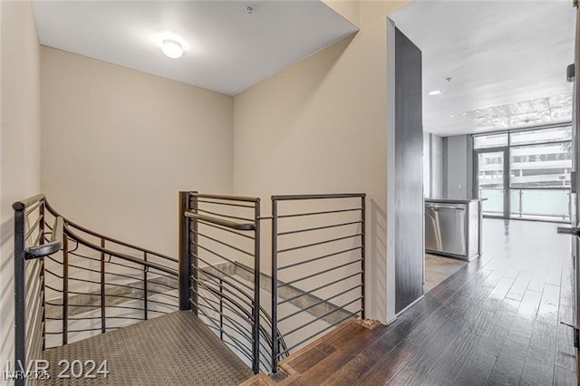 stairs featuring hardwood / wood-style floors