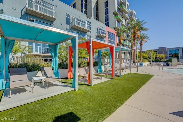 exterior space with a yard and a community pool