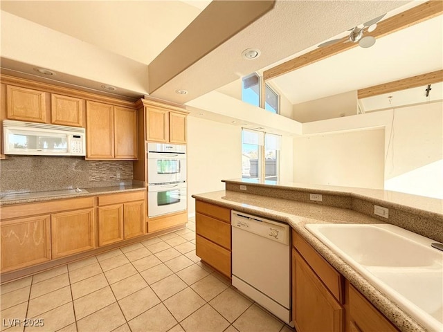 kitchen with backsplash, white appliances, sink, light tile patterned floors, and lofted ceiling with beams