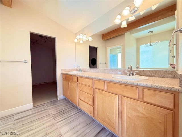 bathroom with vanity and vaulted ceiling