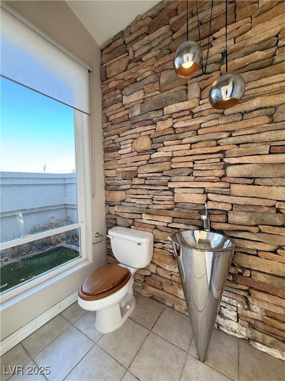 bathroom with tile patterned flooring and toilet