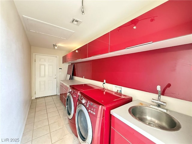 washroom with washer and clothes dryer, light tile patterned floors, and sink