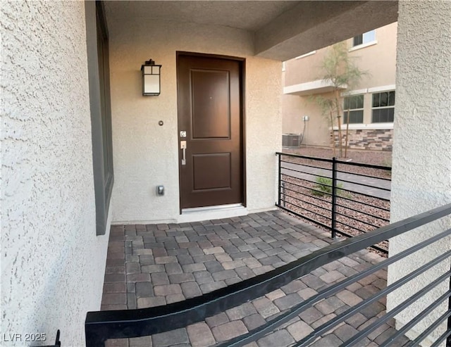 view of exterior entry with a balcony