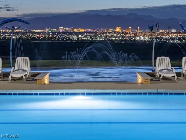 view of swimming pool with pool water feature