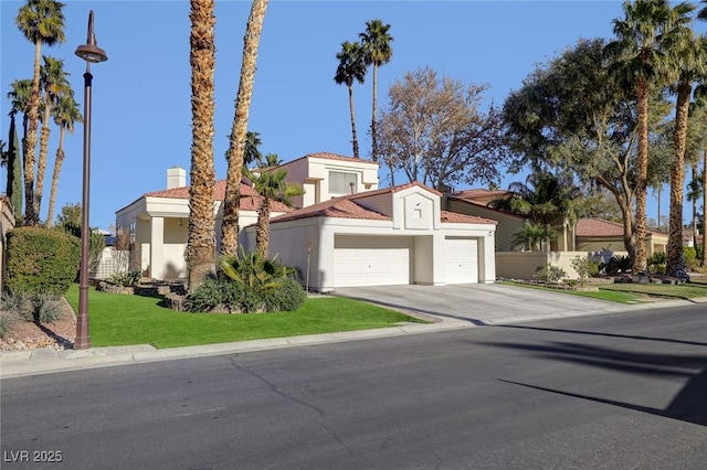 mediterranean / spanish house featuring a front lawn