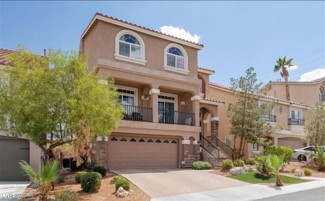 mediterranean / spanish house featuring a balcony and a garage