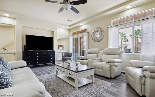 living room with dark hardwood / wood-style floors and ceiling fan