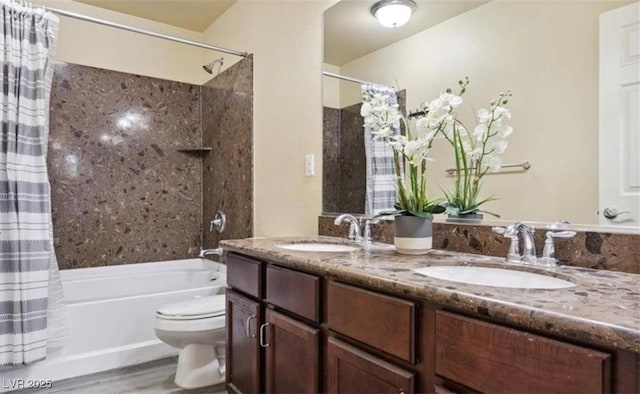 full bathroom featuring hardwood / wood-style floors, vanity, shower / bath combination with curtain, and toilet