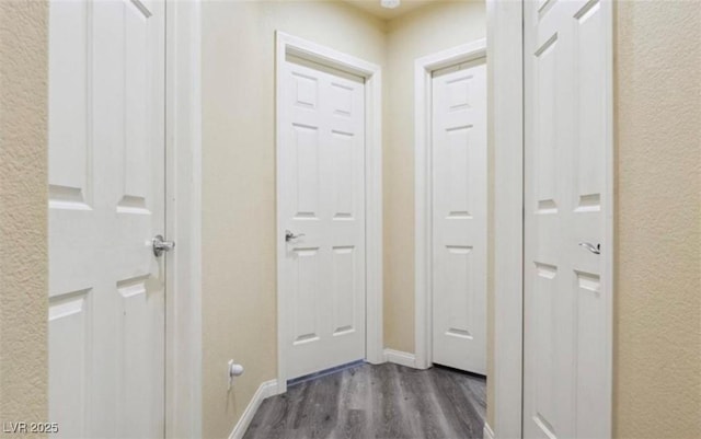 corridor with dark hardwood / wood-style flooring