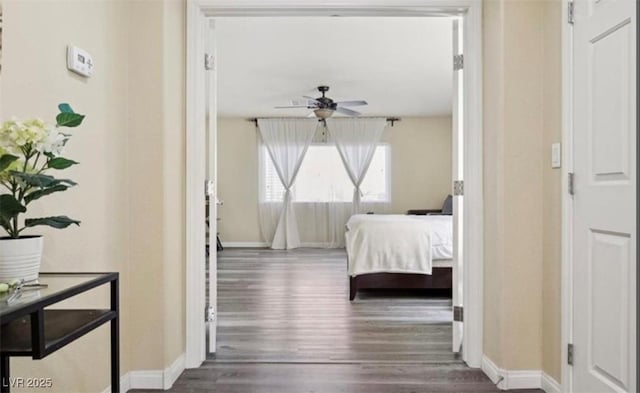 bedroom with ceiling fan and dark wood-type flooring